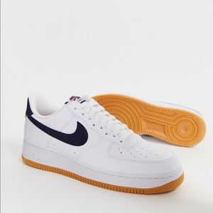 White nike air forces with a navy blue swoosh